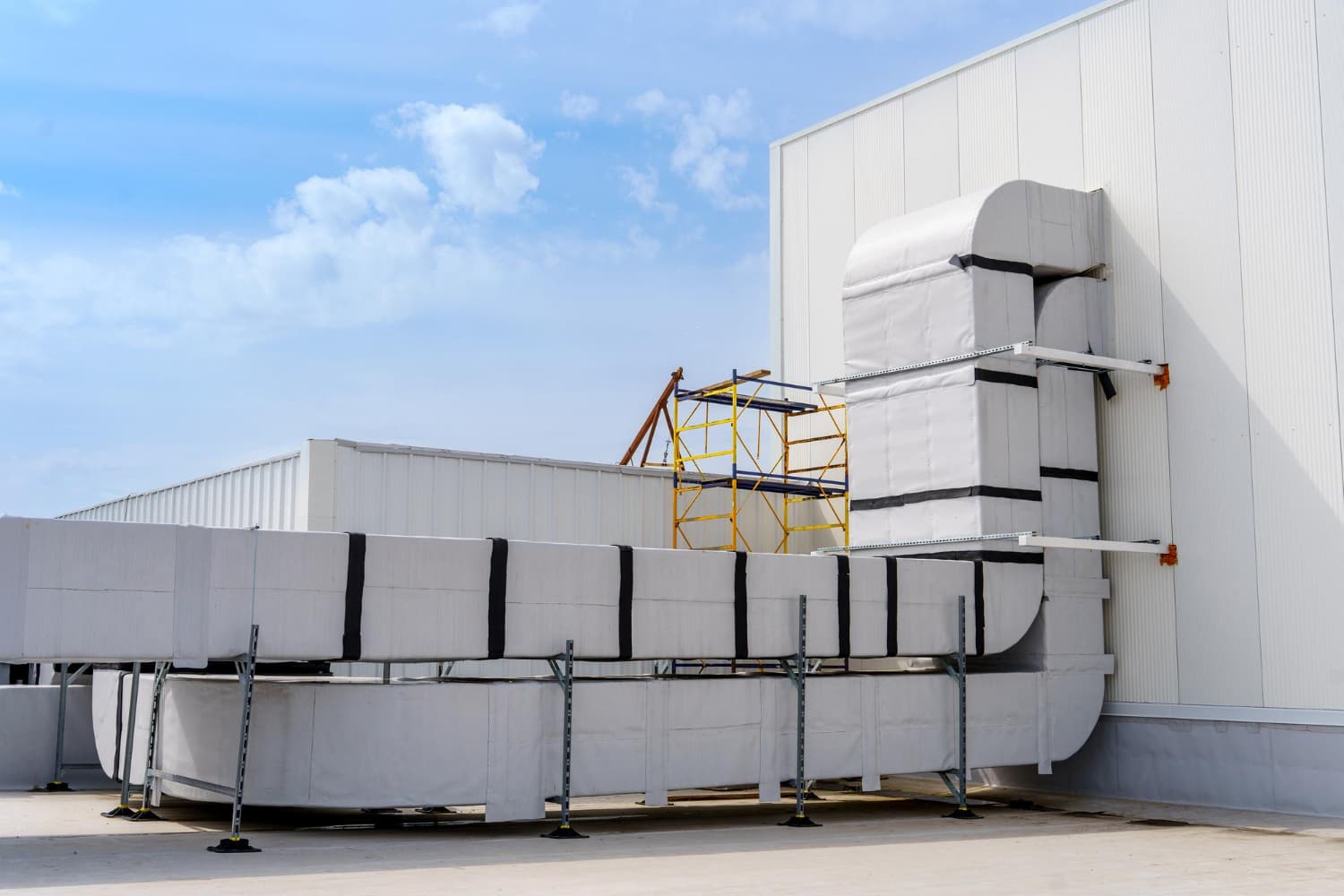 Industrial HVAC units stacked outside a facility