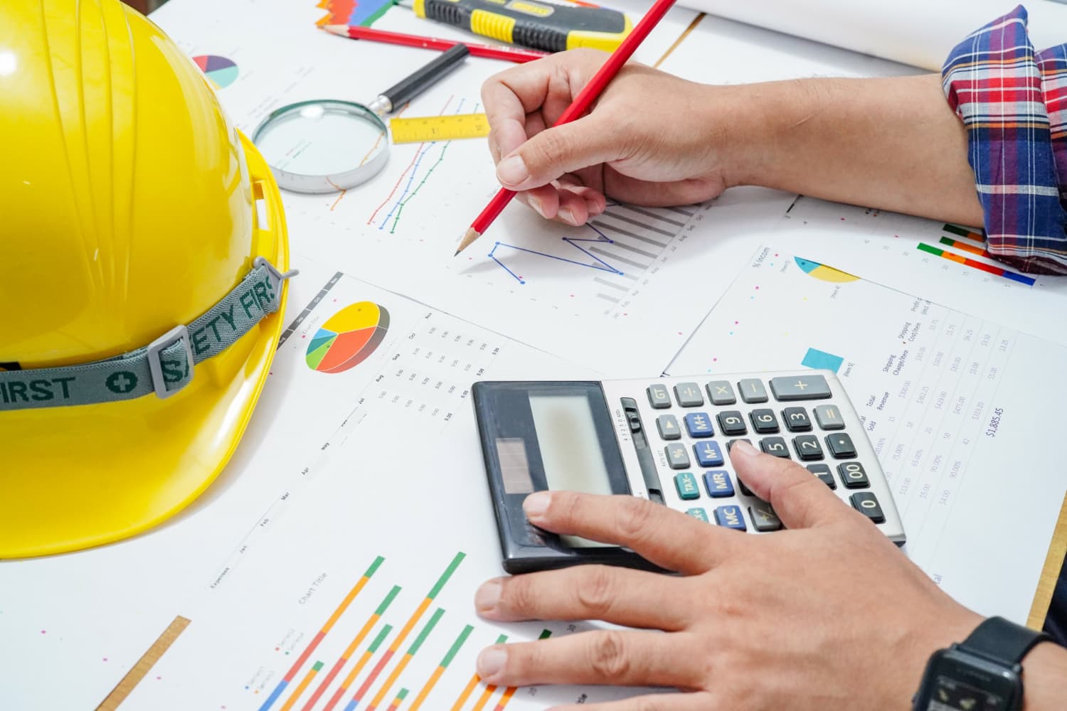 Engineer doing load calculations with charts and calculator